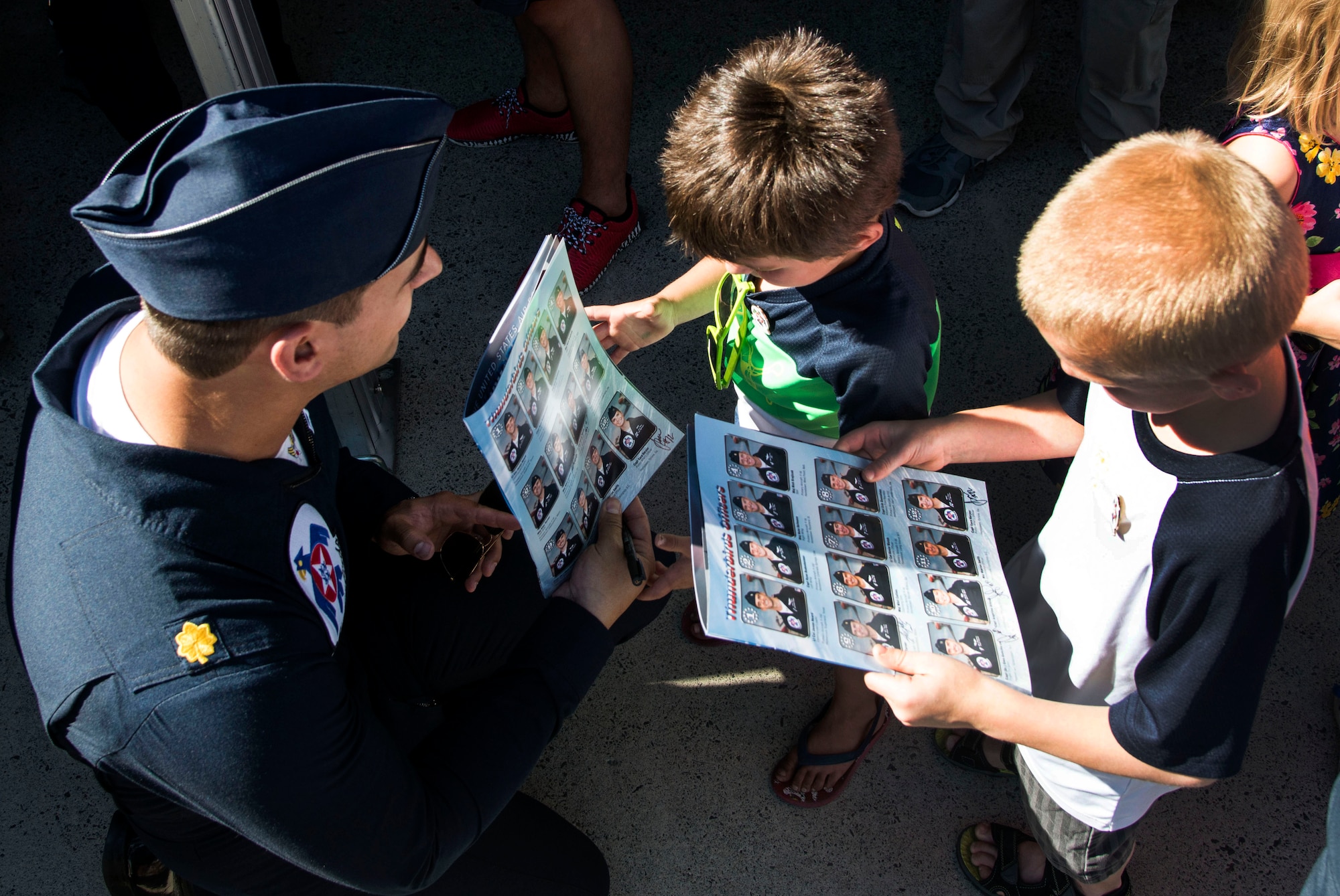 Maj. Whit Collins, U.S. Air Force Aerial Demonstration Squadron “Thunderbirds” pilot #6 signs autographs for the local and regional community during SkyFest 2017 Air Show and Open House at Fairchild Air Force Base, Washington, July 28, 2017. SkyFest was an opportunity to give the local and regional community a chance to view Airmen and our resources. (U.S. Air Force photo/Senior Airman Janelle Patiño)