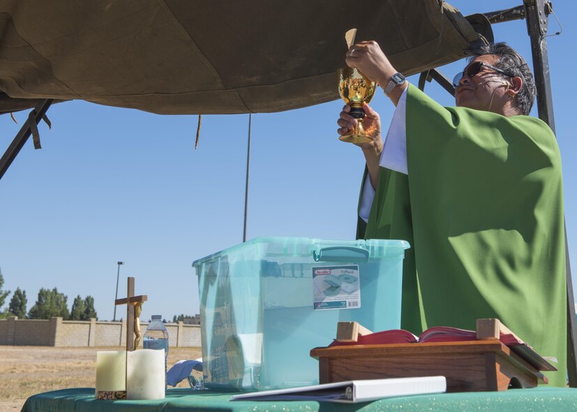 Father Juan Salonga, 92nd Air Refueling Wing Catholic chaplain, gives a Sunday morning service near the flightline prior to the start of Skyfest 2017 air show and open house July 30, 2017, at Fairchild Air Force Base, Washington. Established in 1775, the chaplain corps have served as spiritual, ethical and morale leaders in the U.S. military for over 242 years. (U.S. Air Force photo / Airman 1st Class Ryan Lackey)