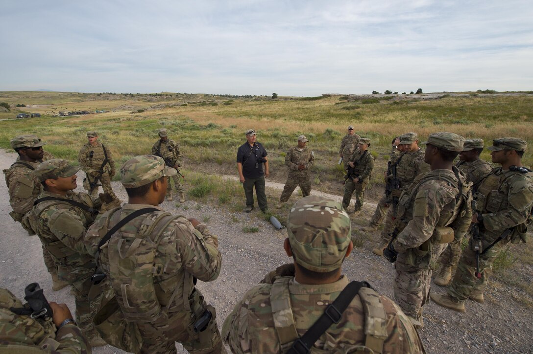 Cayle Harris, 620th Ground Combat Training Squadron counter improvised explosive device instructor, discusses Minot Air Force Base, N.D., 791st Missile Security Forces Squadron Airmen’s performance after a counter IED course at Camp Guernsey, Wyo., July 19, 2017. Harris is a retired U.S. Air Force master sergeant and served more than 20 years in the explosive ordinance disposal career field. (U.S. Air Force photo by Staff Sgt. Christopher Ruano)