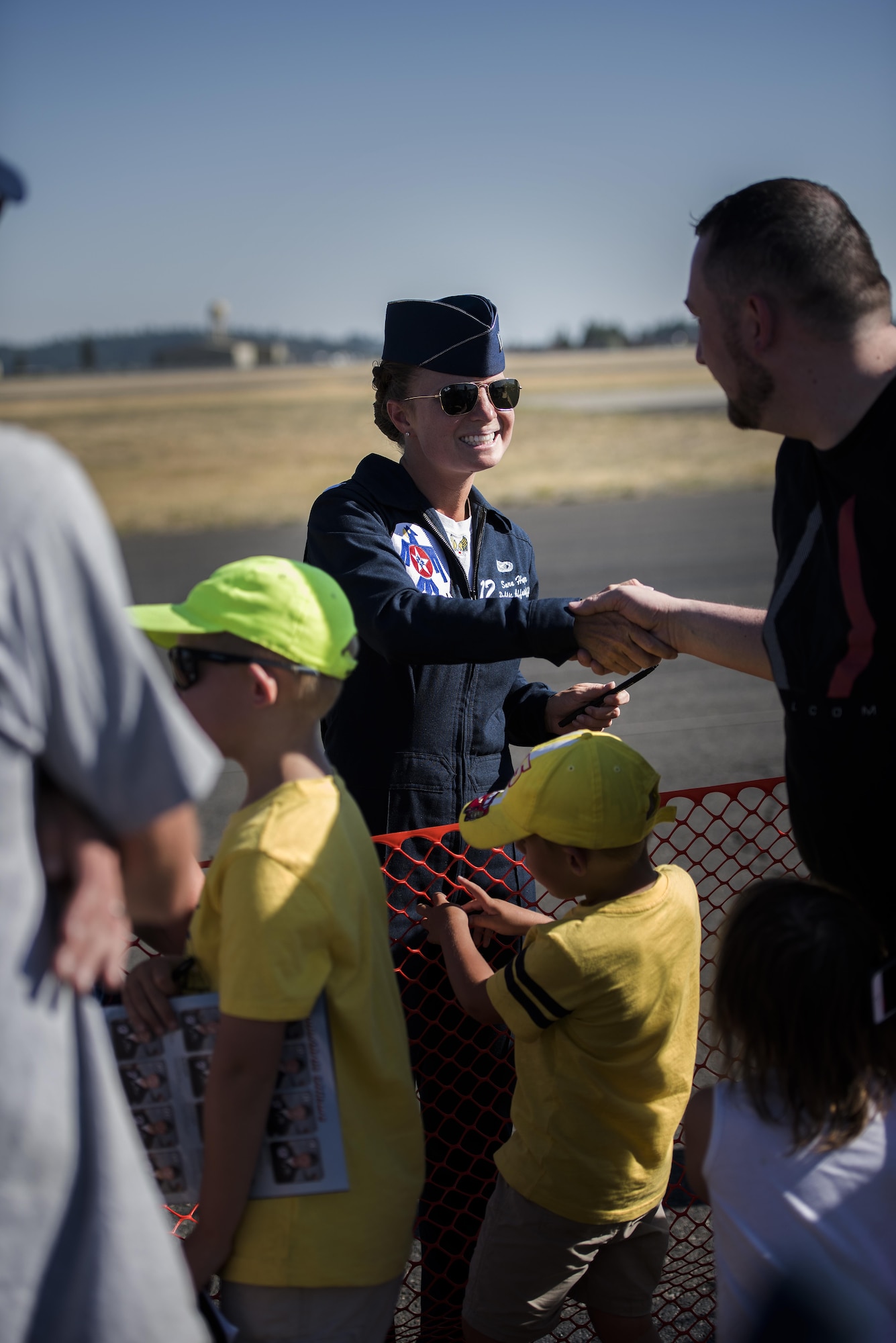 Capt. Sarah Harper, U.S. Air Force Aerial Demonstration Squadron  public affairs officer shakes the hand of a Skyfest 2017 Air Show and Open House attendee July 29, 2017, at Fairchild Air Force Base, Washington. Millions of people have witnessed the Thunderbirds since their beginning, and they continue to show pride, professionalism and the dedication of hundreds of thousands of Airmen serving at home and abroad. (U.S. Air Force photo/ Senior Airman Sean Campbell)  