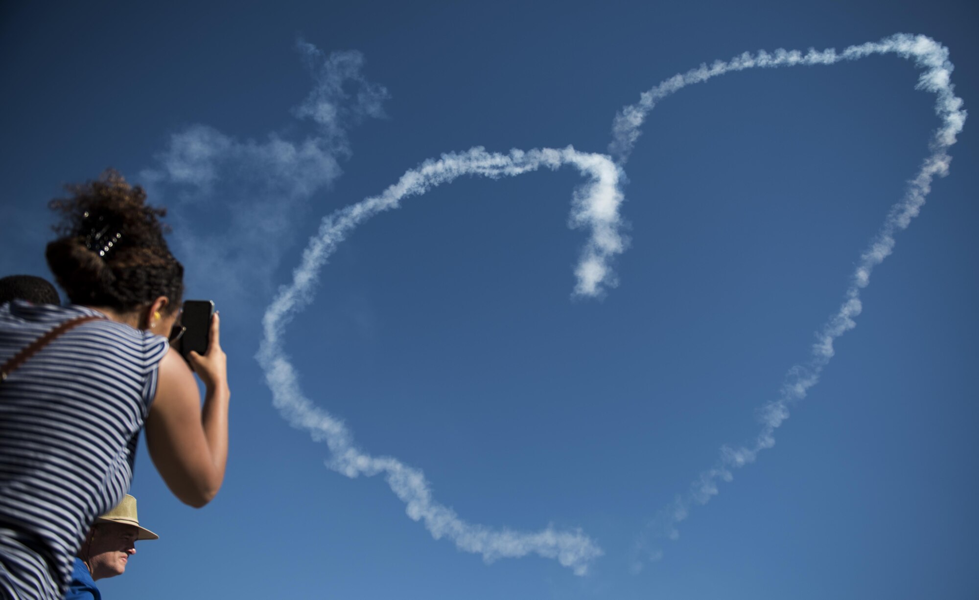 A local community member takes photos of the U.S. Air Force Aerial Demonstration Squadron, the Thunderbirds, performance at Skyfest 2017 Air Show and Open House July 30, 2017, at Fairchild Air Force Base, Washington. SkyFest  is a community event  to inform the public about Air Force assets and to showcase the capabilities of its aircraft. (U.S. Air Force photo/ Senior Airman Sean Campbell) 