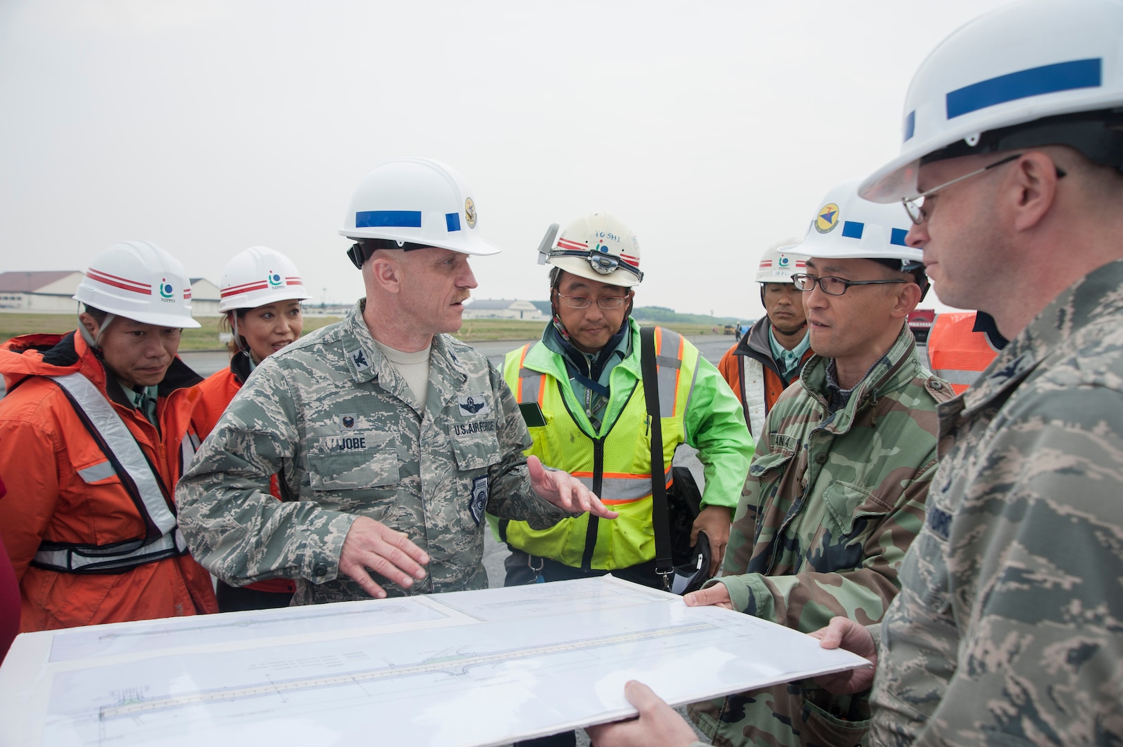 U.S. Air Force Col. R. Scott Jobe, the 35th Fighter Wing commander, discusses construction plans with site leads at Misawa Air Base, Japan, May 25, 2017. The squadron reconstructed a large portion of the runway to further enhance mission quality. (U.S. Air Force photo by Staff Sgt. Melanie Hutto)