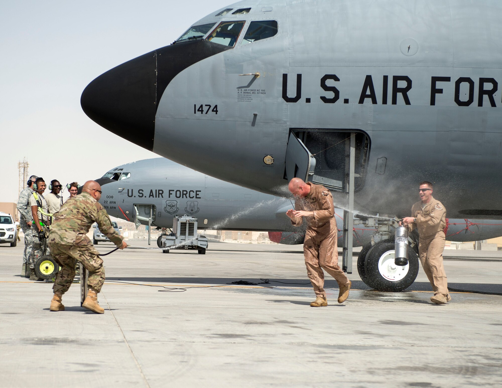 U.S. Air Force Brig. Gen. Darren James, wing commander of the 379th Air Expeditionary Wing, is hosed down with water by follow airmen with the 379th AEW at Al Udeid Air Base, Qatar, May 29, 2017. James just completed his fini-flight which is a time honored aviation tradition that marks the end of his flying status as wing commander of the 379th AEW. During James’ time as wing commander, he flew over 325 hours and 40 sorties.  (U.S. Air Force photo by Tech. Sgt. Amy M. Lovgren)