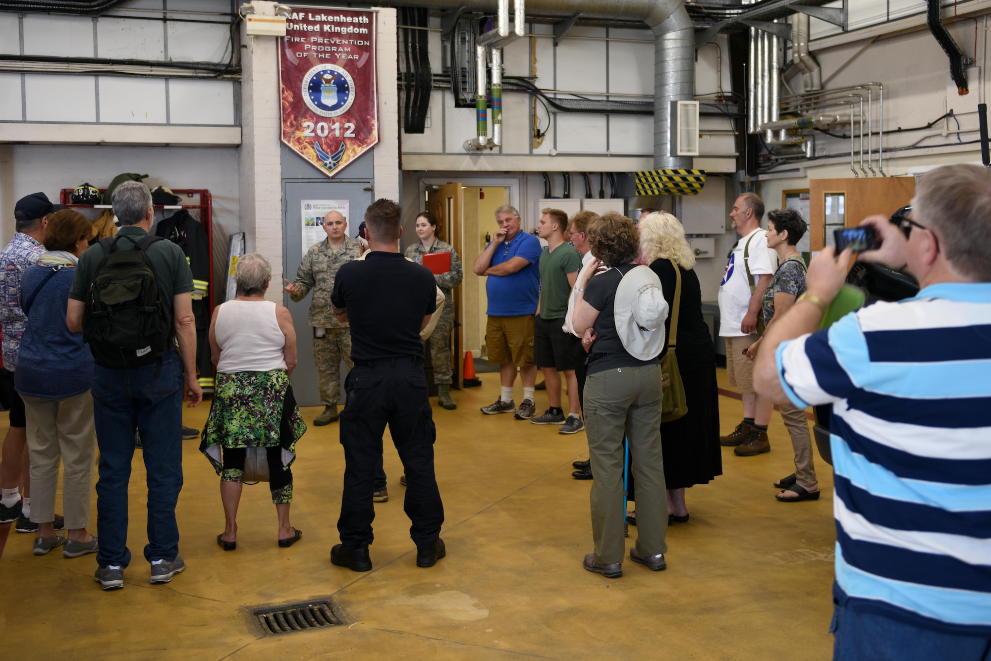 Members of the 305th Bomb Wing Heritage Group listen to a brief about the on base fire department at Royal Air Force Lakenheath, May 25. The 305th Bomb Wing Heritage Group is composed of former Airmen from the 305th or descendants of members from the unit. (U.S. Air Force photo/Airman 1st Class John A. Crawford)