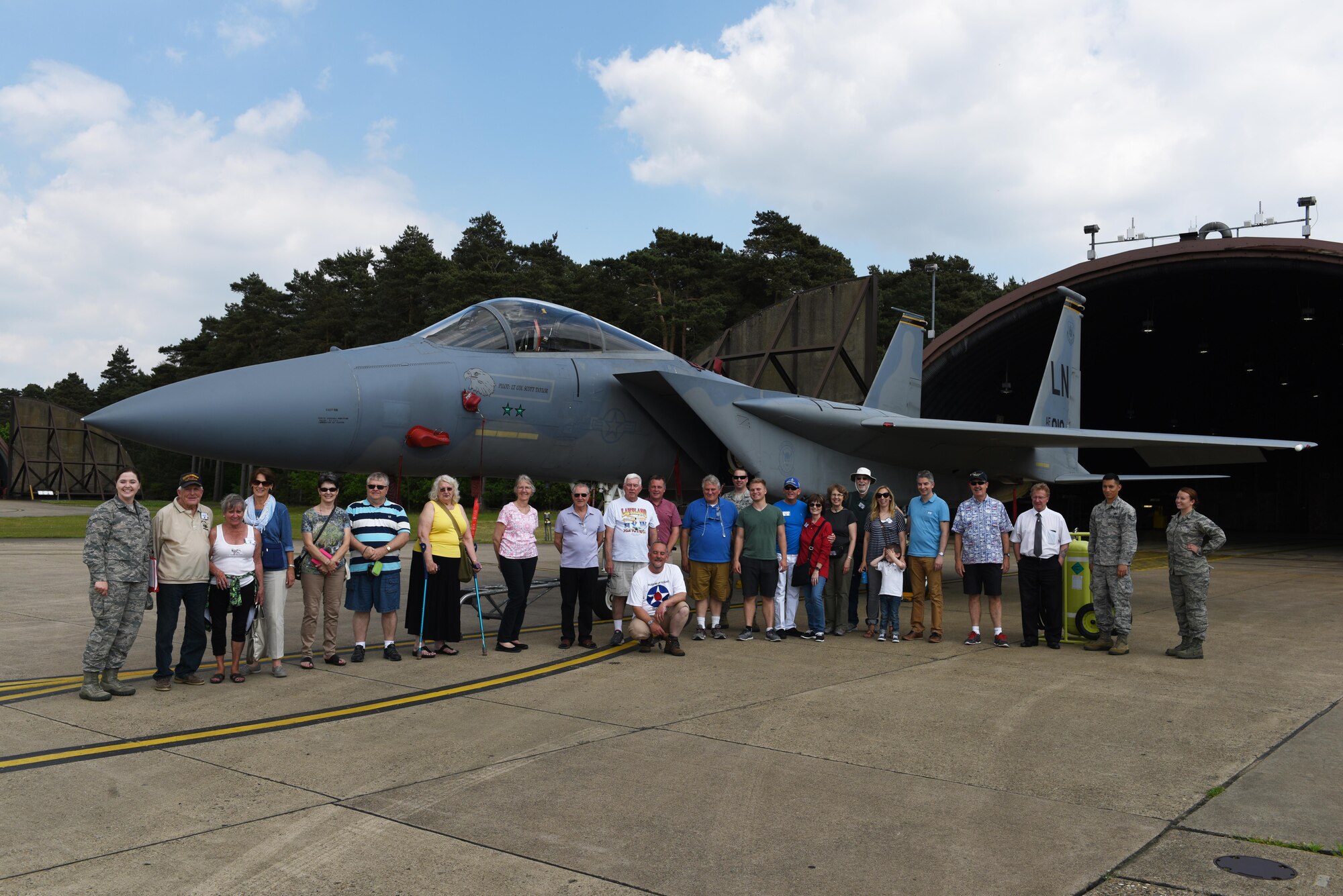 Members of the 305th Bomb Wing Heritage Group pose for a photo with an F-15C Eagle at Royal Air Force Lakenheath, May 25. The 305th Bomb Wing Heritage Group is composed of former Airmen from the 305th or descendants of members from the unit. (U.S. Air Force photo/Airman 1st Class John A. Crawford)