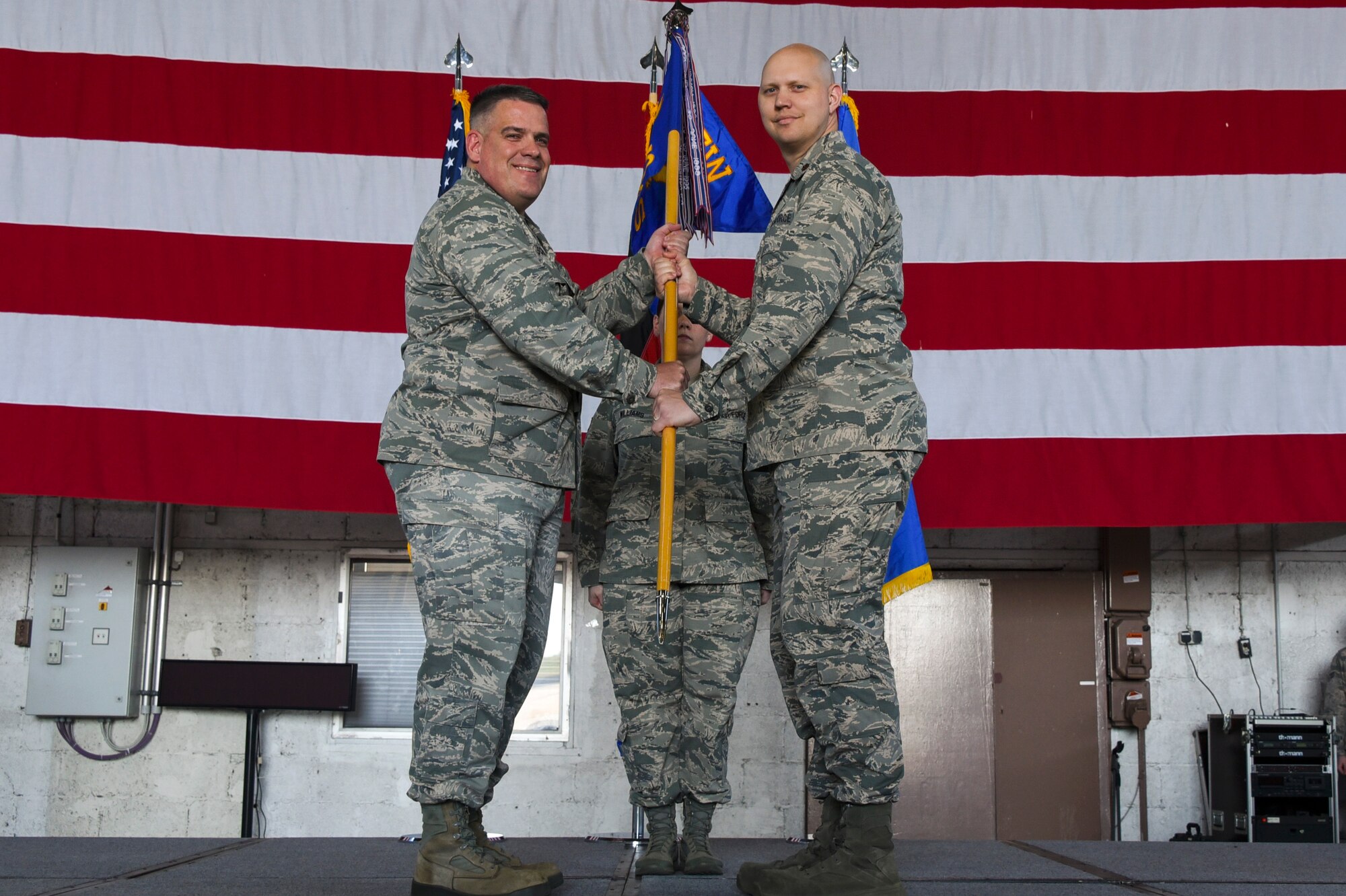 U.S. Air Force Col. Stephen C. Scherzer, 52nd Maintenance Group commander, left, gives the ceremonial guidon to U.S. Air Force Major Christopher R. Pustka, incoming 52nd Maintenance Squadron commander, during the 52nd MXS assumption of command ceremony on Spangdahlem Air Base, Germany, June 1, 2017. (U.S. Air Force photo by Senior Airman Dawn M. Weber)