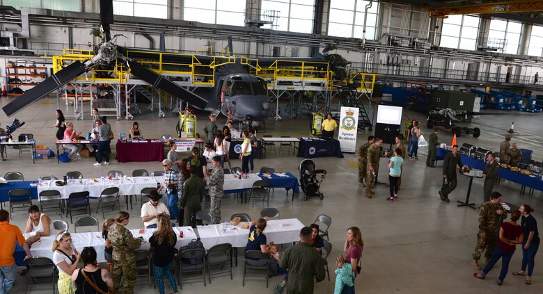 U.S. Air Force Airmen assigned to the 352d Special Operations Wing socialize with their families during Spouses Appreciation Day, May 25, 2017, on RAF Mildenhall, England. Family members had the opportunity to tour static displays and learn about equipment Airmen use to accomplish their daily duties. (U.S. Air Force photo by Senior Airman Justine Rho)