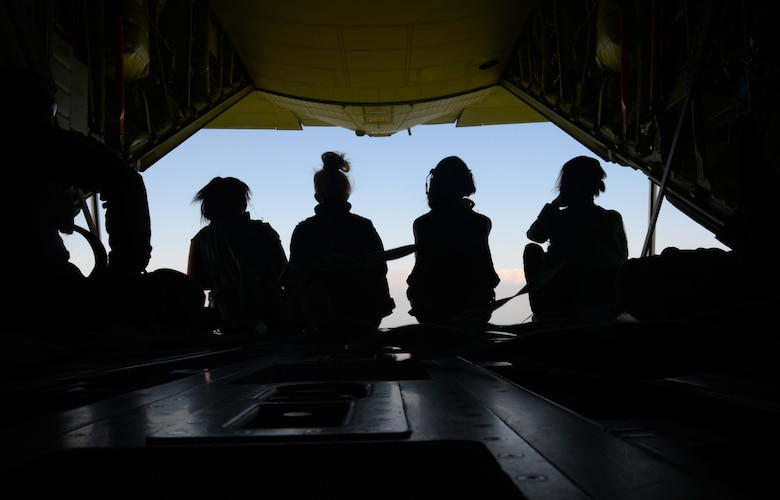 Four spouses sit on the ramp of an MC-130J Commando II during an orientation flight, May 26, 2017, during the 352d Special Operations Wing Spouses Appreciation Day on RAF Mildenhall, England. The flight flew to the White Cliffs of Dover. The orientation flights were provided to give spouses a greater understanding of the mission their Airmen support. (U.S. Air Force photo by Senior Airman Justine Rho)