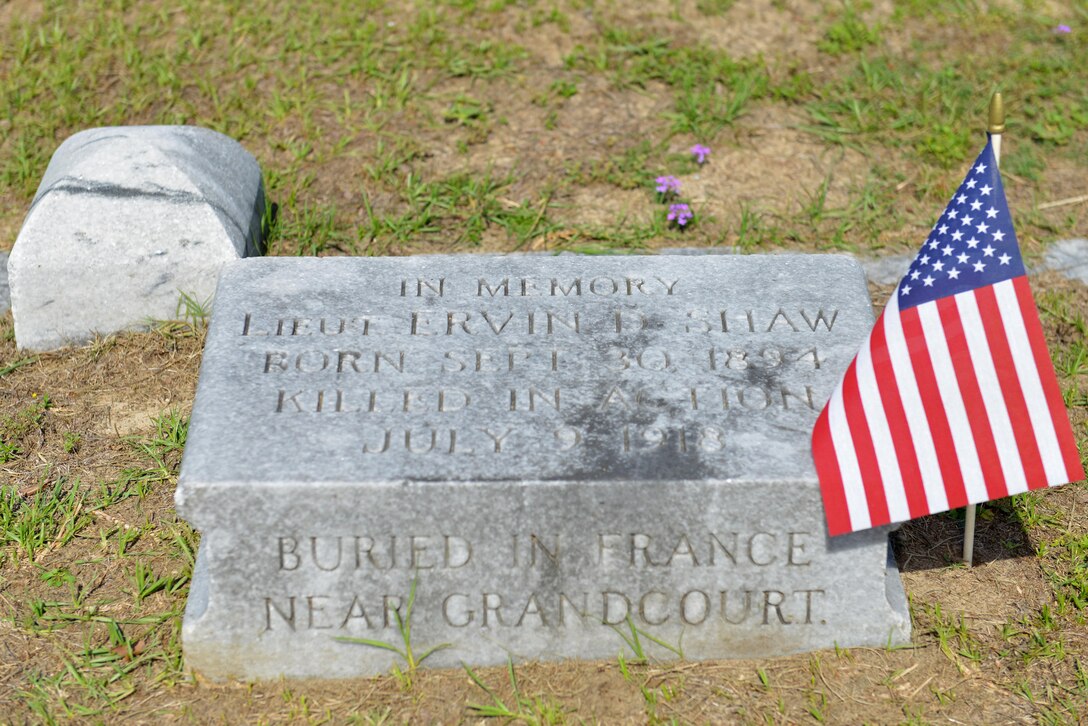 A U.S. flag is placed next to a memorial for Lt. Ervin Shaw, the Airman for whom Shaw Air Force Base, S.C., is named, at Sumter Cemetery in Sumter, S.C., May 27, 2017. Airmen from the 20th Fighter Wing cleaned the gravesites of heroes buried there during a restoration project in remembrance of fallen service members. (U.S. Air Force photo by Airman 1st Class Destinee Sweeney)