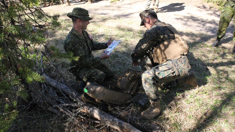 COLD LAKE, AB, CANADA – Marines with Engineer Company, Detachment Bravo, Marine Wing Support Squadron 473, 4th Marine Aircraft Wing, Marine Forces Reserve, measure detonating cord to create a field expedient Bangalore torpedo, May 28, 2017. Marines trained in obstacle breaching, clearing an abatis crated by Canadian Armed Forces members as part of exercise Maple Flag 50.