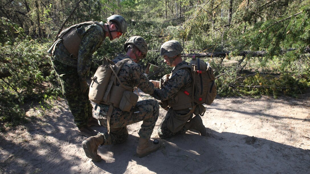 COLD LAKE, AB, CANADA – Marines with Engineer Company, Detachment Bravo, Marine Wing Support Squadron 473, 4th Marine Aircraft Wing, Marine Forces Reserve, measure detonating cord to create a field expedient Bangalore torpedo, May 28, 2017. Marines trained in obstacle breaching, clearing an abatis crated by Canadian Armed Forces members as part of exercise Maple Flag 50.