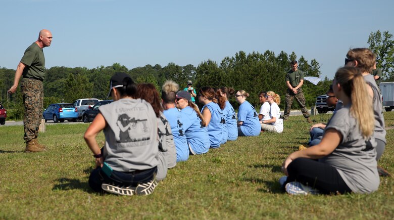 Staff Sgt. Brian Gorman, a former drill instructor, gives a speech to the spouses of Marines participating in a squadron Jane Wayne Day at Marine Corps Air Station Cherry Point, N.C., May 20, 2017. Marines of all ranks and their spouses are invited to participate in Jane Wayne Day to provide spouses with unique experiences. With every event, new obstacles and challenges are presented, allowing family members to gain a full experience of what it is like to walk in the combat boots of their service member. Gorman is the airframe SNCOIC assigned to Marine Attack Squadron 203, Marine Aircraft Group 14, 2nd Marine Aircraft Wing. (U.S. Marine Corps photo by Lance Cpl. Justin Roux/ Released)