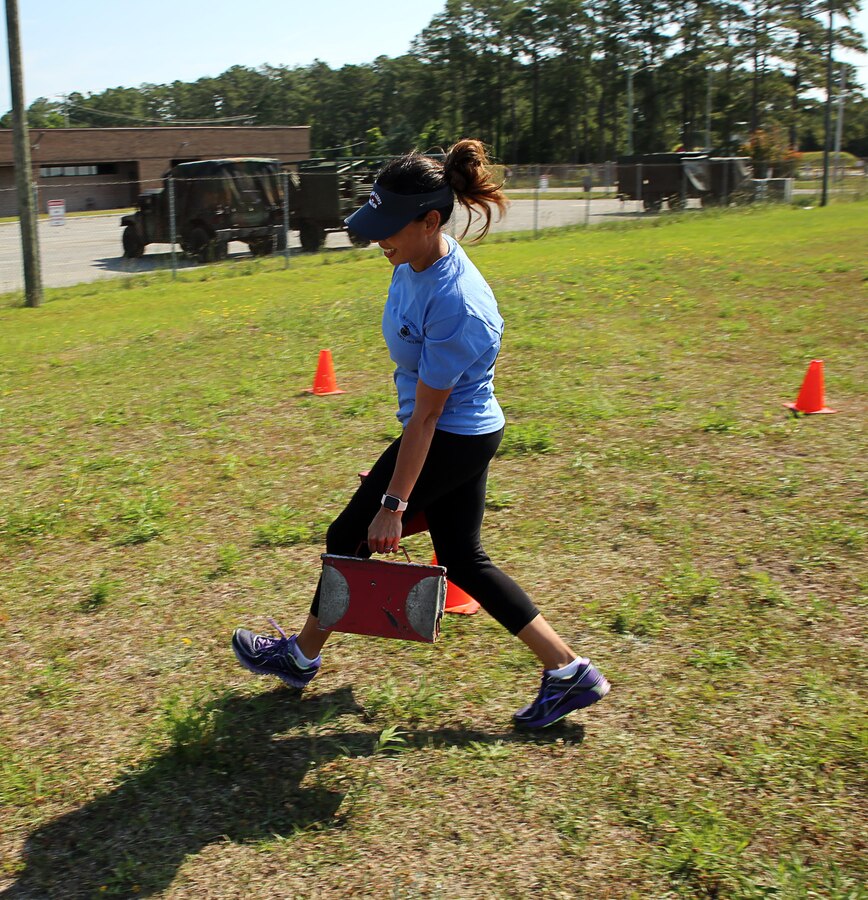 Adrianna Vallario, wife of Lt. Col. James Vallario, performs the ammo can sprint portion of a modified combat fitness test during a squadron Jane Wayne Day at Marine Corps Air Station Cherry Point, N.C., May 20, 2017. Jane Wayne Days like these are held all across the Marine Corps to build unit cohesion, and provide family members the opportunity to experience what their Marine do day-to-day. These events include a wide range of training exercises such as the combat fitness test, weapons qualification range, Marine Corps Martial Arts Program, and more. Vallario is the commanding officer of Marine Attack Training Squadron 203, Marine Aircraft Group 14, 2nd Marine Aircraft Wing. (U.S. Marine Corps photo by Lance Cpl. Justin Roux/Released)
