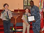 DAHLGREN, Va. (May 24, 2017) - Boy Scouts Drew Warder and Lucas Umberger present Naval Surface Warfare Center Dahlgren Division Commanding Officer Capt. Godfrey 'Gus' Weekes with a Certificate of Appreciation after his speech to Boy Scout Troop 1404. Weekes spoke to the troop about his Navy career and world-wide travels, citing examples of the importance of being prepared and looking out for shipmates, fellow scouts, and teammates in any situation, to include hiking and camping expeditions.

