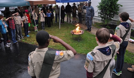 DAHLGREN, Va. (May 24, 2017) - Naval Surface Warfare Center Dahlgren Division (NSWCDD) Commanding Officer Capt. Godfrey 'Gus' Weekes, Boy Scout Troop 1404, and parents of Boy Scouts salute as an American flag that once flew over an NSWCDD building is retired during a ceremony outside of the Dahlgren United Methodist Church. Weekes spoke to the Boy Scouts during their troop meeting prior to the flag retirement ceremony he presided over. 