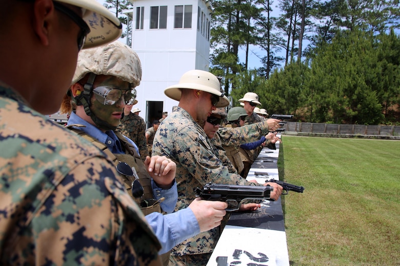 Spouses of Marines assigned to 2d Low Altitude Air Defense Battalion, Marine Aircraft Group 14, 2nd Marine Aircraft Wing, prepare to fire the Beretta M9 pistol during a squadron Jane Wayne Day at Marine Corps Air Station Cherry Point, N.C., May 19, 2017. Marines of all ranks and their spouses are invited to participate in Jane Wayne Day to provide spouses with unique experiences. With every event, new obstacles and challenges are presented, allowing family members to gain a full experience of what it is like to walk in the combat boots of their service member. (U.S. Marine Corps photo by Cpl. Mackenzie Gibson/ Released)