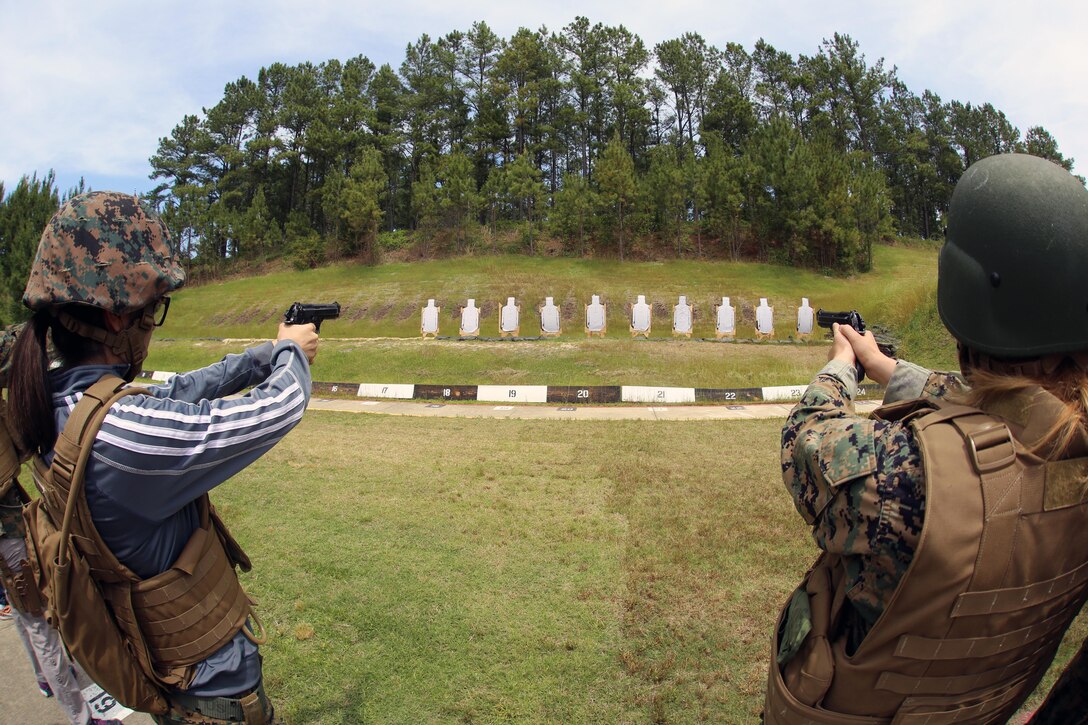 Spouses of Marines assigned to 2d Low Altitude Air Defense Battalion, Marine Aircraft Group 14, 2nd Marine Aircraft Wing, fire the Beretta M9 pistol during a squadron Jane Wayne Day at Marine Corps Air Station Cherry Point, N.C., May 19, 2017. Jane Wayne Days like these are held all across the Marine Corps to build unit cohesion, and provide family members the opportunity to experience what their Marine do day-to-day. These events include a wide range of training exercises such as the combat fitness test, weapons qualification range, Marine Corps Martial Arts Program, and more. (U.S. Marine Corps photo by Cpl. Mackenzie Gibson/ Released)