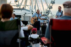 Master Sgt. Joseph Haughton, U.S. Air Force Band’s Celtic Aire ensemble vocalist, plays a guitar during a Memorial Day weekend concert at the National Harbor in Fort Washington, Md., May 27, 2017. This performance kicked off their Summer Concert Series that includes free shows open to the public every Saturday at the National Harbor where people can enjoy traditional and folk music honoring service members. (U.S. Air Force photo by Airman 1st Class Valentina Lopez)