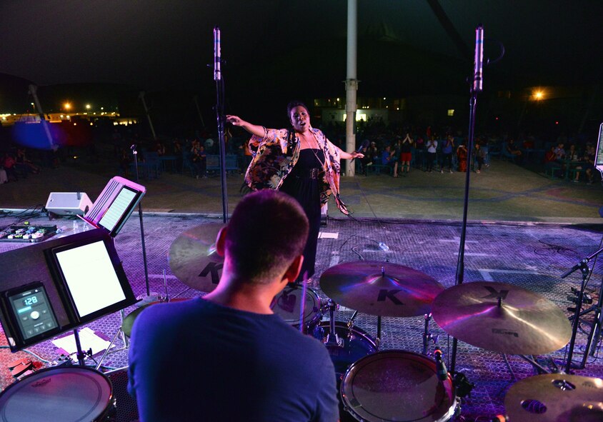 Melinda Doolittle, an accomplished vocalist and top finisher on American Idol, holds a concert with music and backup singing from members of the Air Forces Central Command Band at Al Udeid Air Base, Qatar, May 25, 2017. Doolittle performed for service members deployed overseas, accompanied by the Air Forces Central Command Band. (U.S. Air Force photo by Tech. Sgt. Bradly A. Schneider/Released)