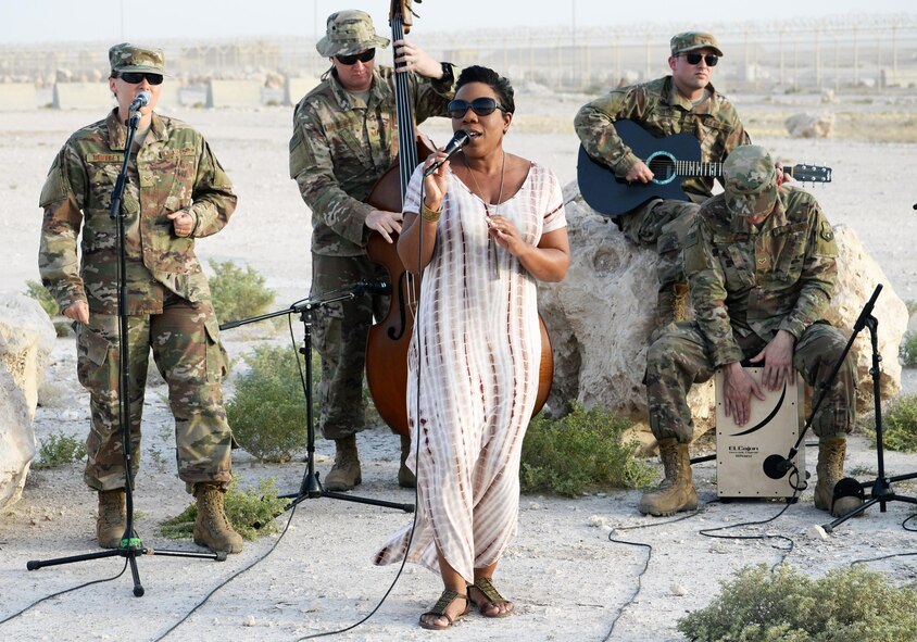 Members of the Air Forces Central Command Band play with Melinda Doolittle, an accomplished vocalist and top finisher on American Idol, at an outside venue in preparation for a concert at Al Udeid Air Base, Qatar, May 25, 2017. Doolittle performed for service members deployed overseas, accompanied by the Air Forces Central Command Band. (U.S. Air Force photo by Tech. Sgt. Bradly A. Schneider/Released)