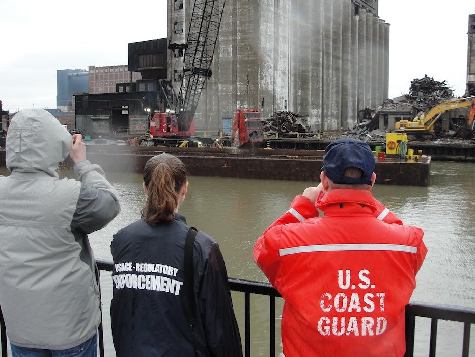Corps of Engineers Regulatory observe the removal of grain silo debris from the Buffalo River. 