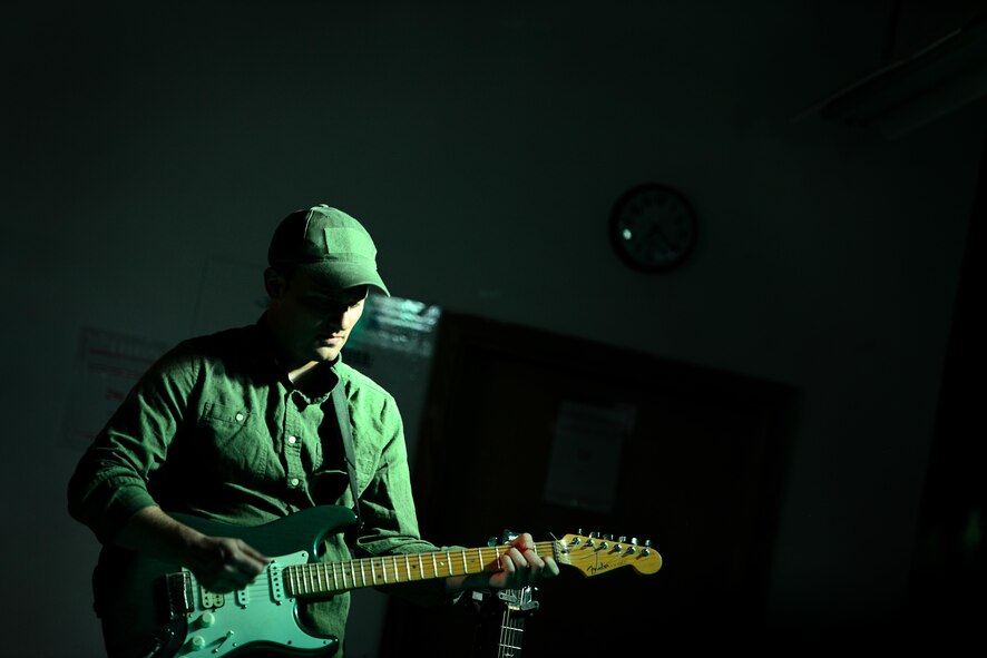 U.S. Air Force Airman 1st Class Josiah Joyce, guitarist for the U.S. Air Forces Central Command Band, plays his solo during a performance for a crowd of U.S. service members and coalition partners during a tour in Southwest Asia on May 31, 2017. The USAFCENT Band rotates several ensembles through the area of responsibility and perform a wide variety of musical styles to appeal to audiences of all ages and backgrounds. (U.S. Air Force Tech Sgt. Andy M. Kin)