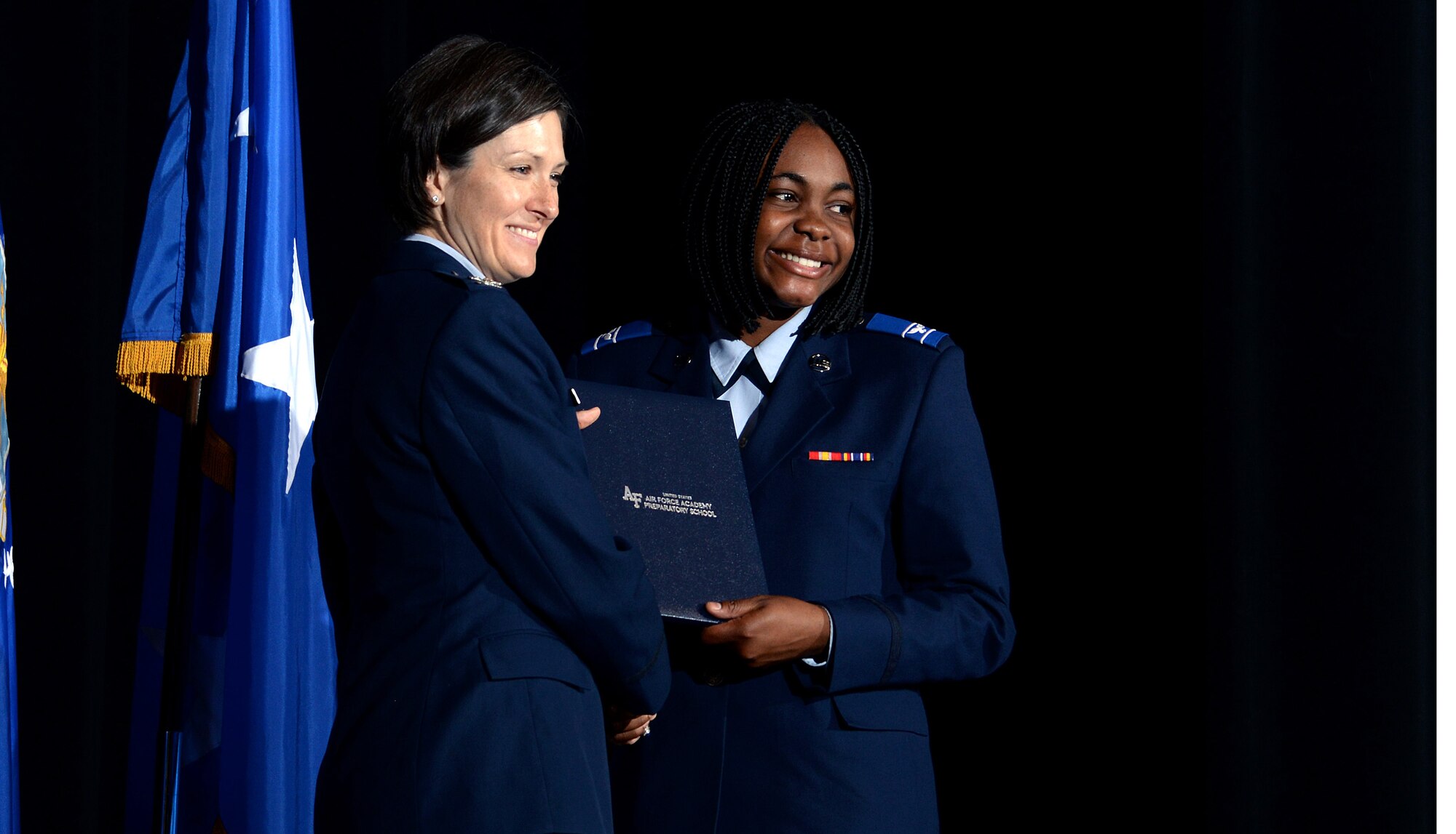 Col. Jacqueline Breeden, commander of the U.S. Air Force Academy Preparatory School, gives a prep school diploma to a graduating cadet-candidate May 18, 2017, at the Community Center Theater. In all, 194 cadet-candidates graduated and 186 cadet-candidates received appointments to the Academy. (U.S. Air Force photo/Jason Gutierrez) 