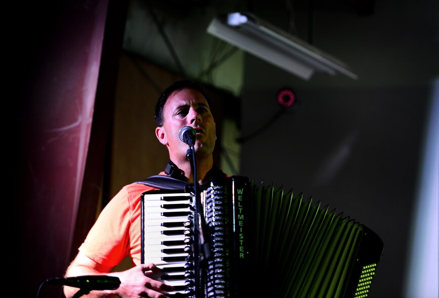 U.S. Air Force Tech Sgt. Ryan Janus, pianist for the U.S. Air Forces Central Command Band, plays his accordion during a performance for a crowd of U.S. service members and coalition partners during a tour in Southwest Asia on May 31, 2017. The USAFCENT Band rotates several ensembles through the area of responsibility and perform a wide variety of musical styles to appeal to audiences of all ages and backgrounds. (U.S. Air Force Tech Sgt. Andy M. Kin)