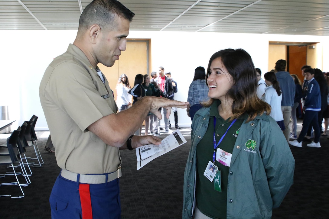 Major David Arellano, a Marine Corps Recruiting Command recruiting support officer, explains a scenario to Meydi Mejia, who is a junior from Grace King High School, during the Latinos on the Fast Track Program’s Body, Mind and Spirit Seminar held at Tulane University in New Orleans on April 24, 2017.  As part of the seminar, students filled leadership roles as they were tasked with guiding their teams through various scenarios. (U.S. Marine Corps photo by Staff Sgt. Rubin J. Tan/Released)