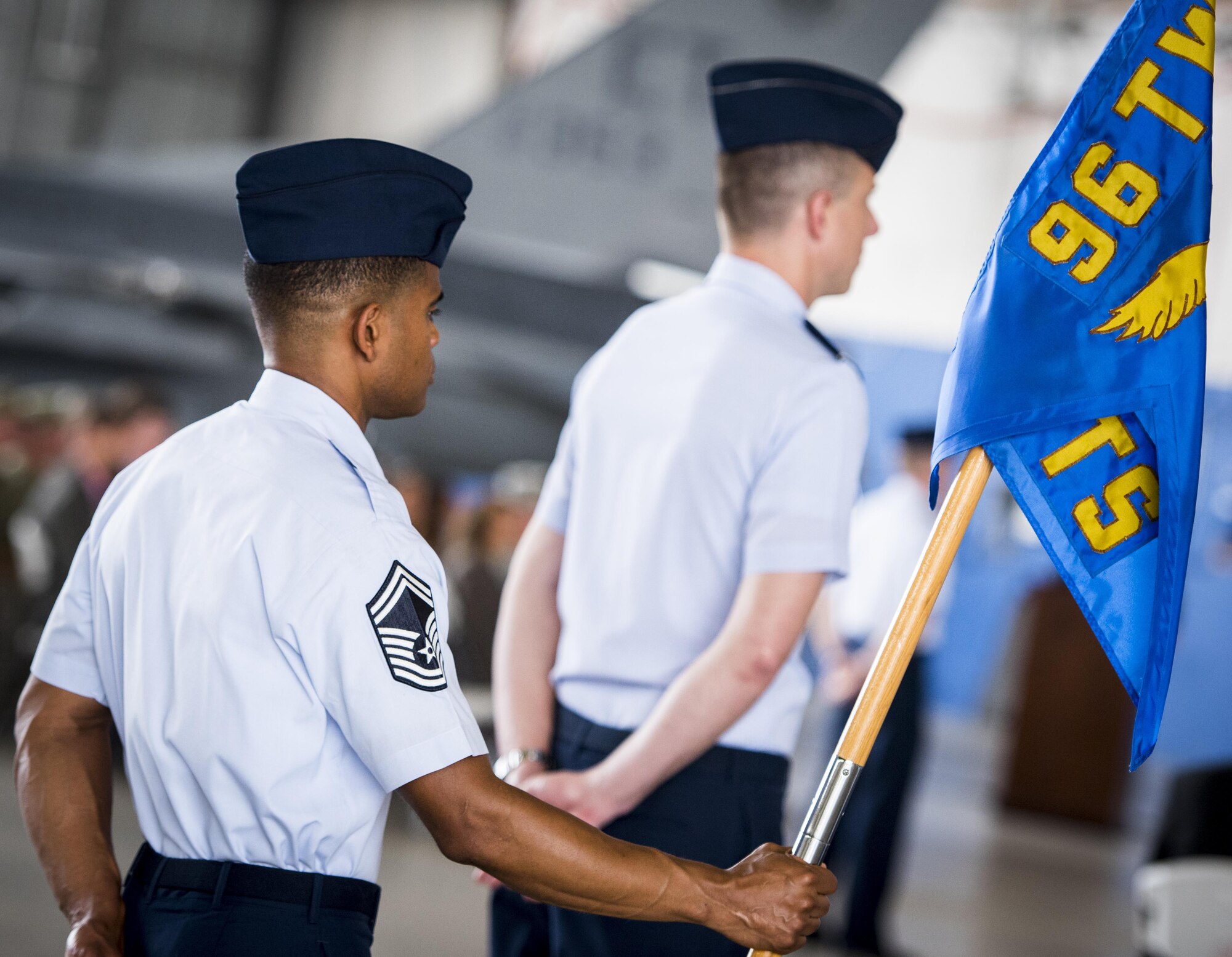 A senior master sergeant holds the 96th Comptroller Squadron guidon during the 96th Test Wing change of command ceremony at Eglin Air Force Base, Fla., May 31.  Brig. Gen. Christopher Azzano relinquished command to Brig. Gen. Evan Dertien.  The command position is Dertien’s third assignment to Team Eglin.  (U.S. Air Force photo/Samuel King Jr.)