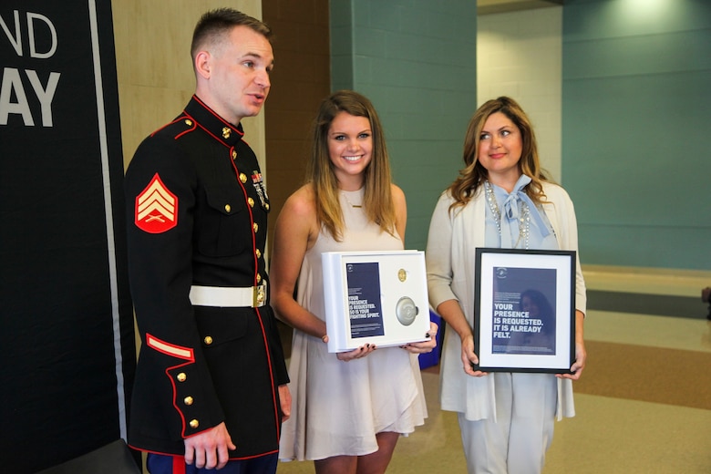 U.S. Marine Sgt. Roderick Evans presents Natasha Kusibab and her mentor, Belinda Kusibab, an invitation to attend the 2017 Battles Won Academy at Brentwood High School, Brentwood, Tennessee, on May 9, 2017. The Battles Won Academy taps into the irreducible essence of the Marine Corps, which is the fighting spirit of the Marine. The essence of the Marines individually and collectively is the willingness to engage and the determination to defeat an opposing force – whether personal or on behalf of our nation and its communities. (U.S. Marine Corps photo by Sgt. Mandaline Hatch)
