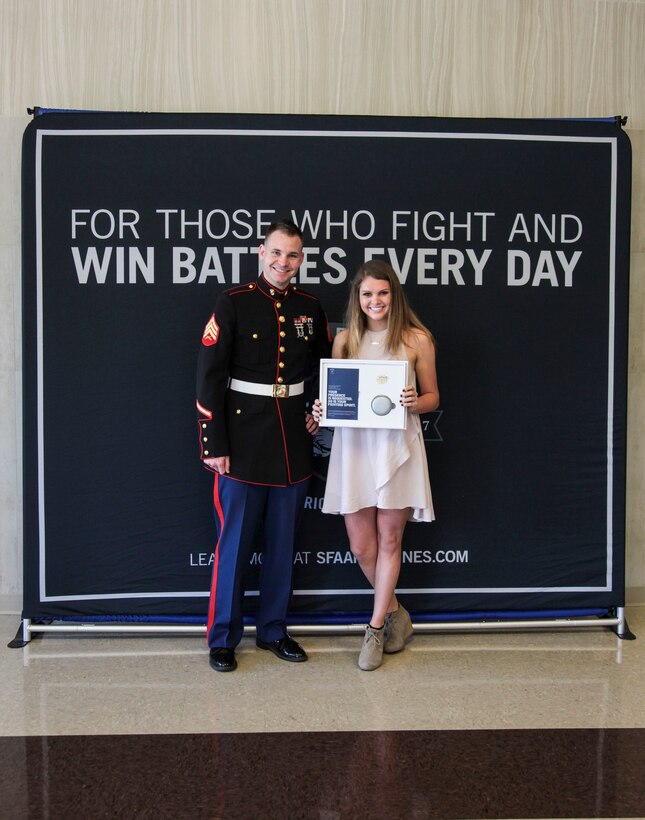 U.S. Marine Sgt. Roderick Evans presents the All-American Natasha Kusibab an invitation to attend the 2017 Battles Won Academy at Brentwood High School, Brentwood, Tennessee, on May 9, 2017. The All-Americans will participate in an immersive Marine Corps experience, teambuilding outings, sporting events, and behind-the-scenes tours of our Nation’s Capital. The selected Semper Fidelis All-Americans will also have the opportunity to network with an elite circle of speakers from all walks of life and various industries who will share their inspiring stories of fighting and winning battles in their own lives. (U.S. Marine Corps photo by Sgt. Mandaline Hatch)