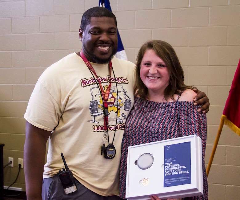 Gracyn LaSueur (right) poses with her strength and conditioning coach, Derrick Bumpers (left) after being present with the Semper Fidelis All-American Award at Northview High School, May 18, 2017. LaSueur is exactly what the Marine Corps is looking for when it comes to a Semper Fidelis All-American. She has turned her obstacles into victories by overcoming odds set against her at a very early age. She dedicates her success to Coach Bumpers who aided her in her recovery after not only tearing her meniscus, but straining her medial collateral ligament (MCL) as well.  (U.S. Marine Corps photo by Cpl. Krista James/Released)