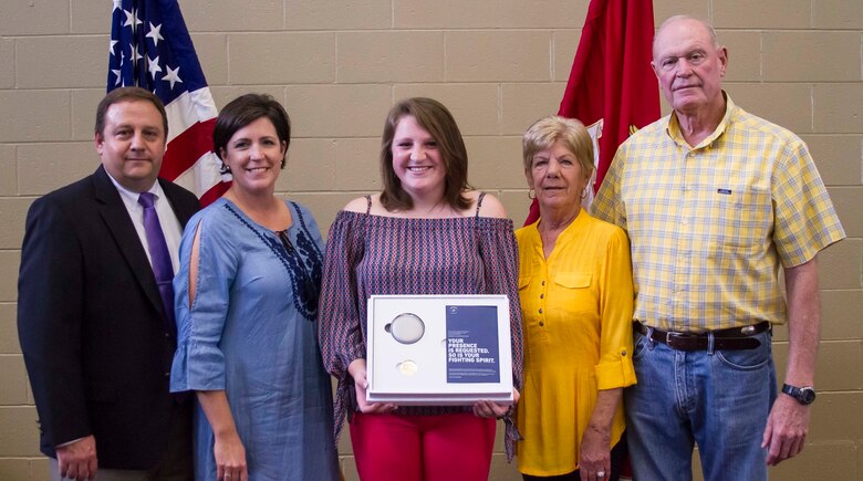 Gracyn LeSueur (center) poses for a photo with her parents, Kevin and Michelle LaSueur (left), and her grandparents, Grace and Doug Bennefield (right), after being presented with the Semper Fidelis All-American award at Northview High School, May 18, 2017. LaSueur was one of 100 students who will attend the Battles Won Academy this summer in Washington D.C., where she will be given the opportunity to network with and hear from an elite circle of leaders from all walks of life, who like her, have fought and won their own battles. (U.S. Marine Corps photo by Cpl. Krista James/Released)