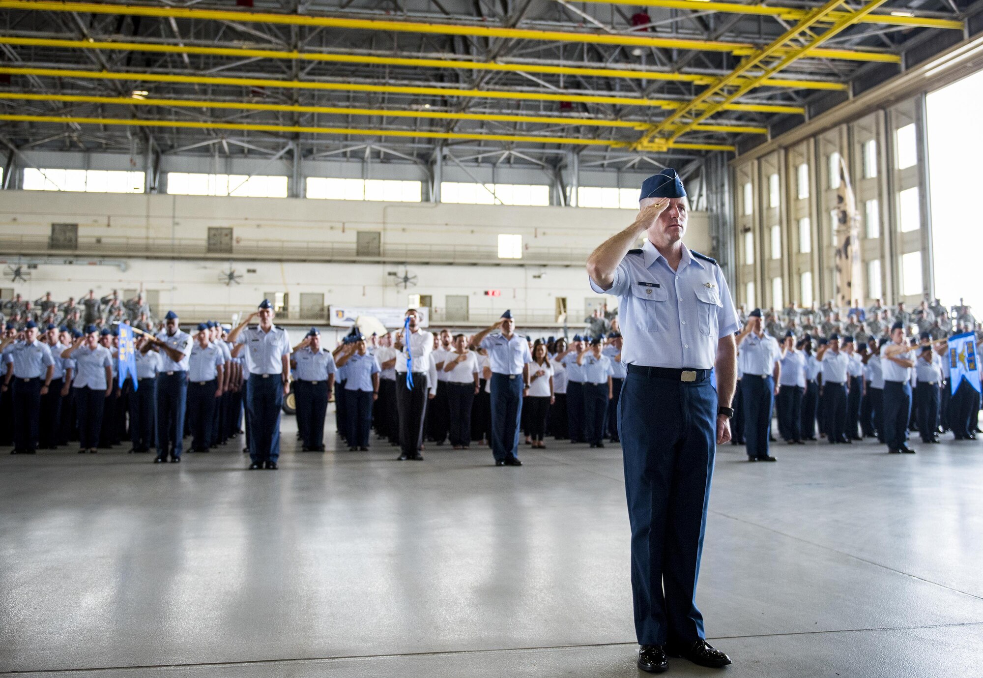 Col. Matthew Higer, 96th Test Wing vice commander, leads the group formations in saluting during the National Anthem at the wing’s change of command ceremony at Eglin Air Force Base, Fla., May 31.  Brig. Gen. Christopher Azzano relinquished command to Brig. Gen. Evan Dertien.  The command position is Dertien’s third assignment to Team Eglin.  (U.S. Air Force photo/Samuel King Jr.)