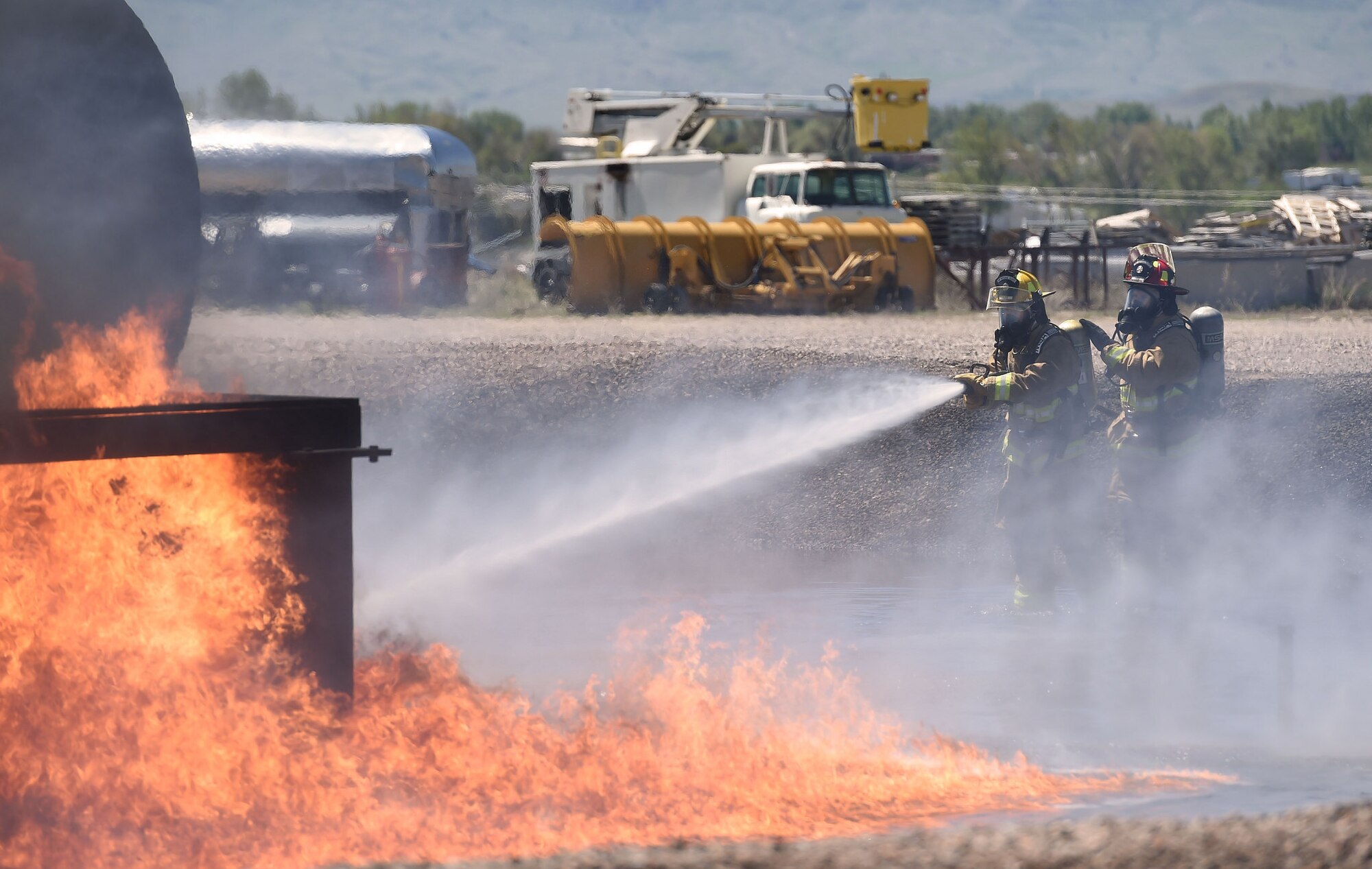 Camp Guernsey Fire Department and Wyoming Air Guard firefighters train together at the Wyoming Airport Rescue Fire Fighting Training Facility in Casper May 24. The facility is one of few in the nation where firefighters can meet their annual certification requirements on a live diesel or jet fuel burn. (Wyoming Army National Guard photo by Sgt. 1st Class Jimmy McGuire)