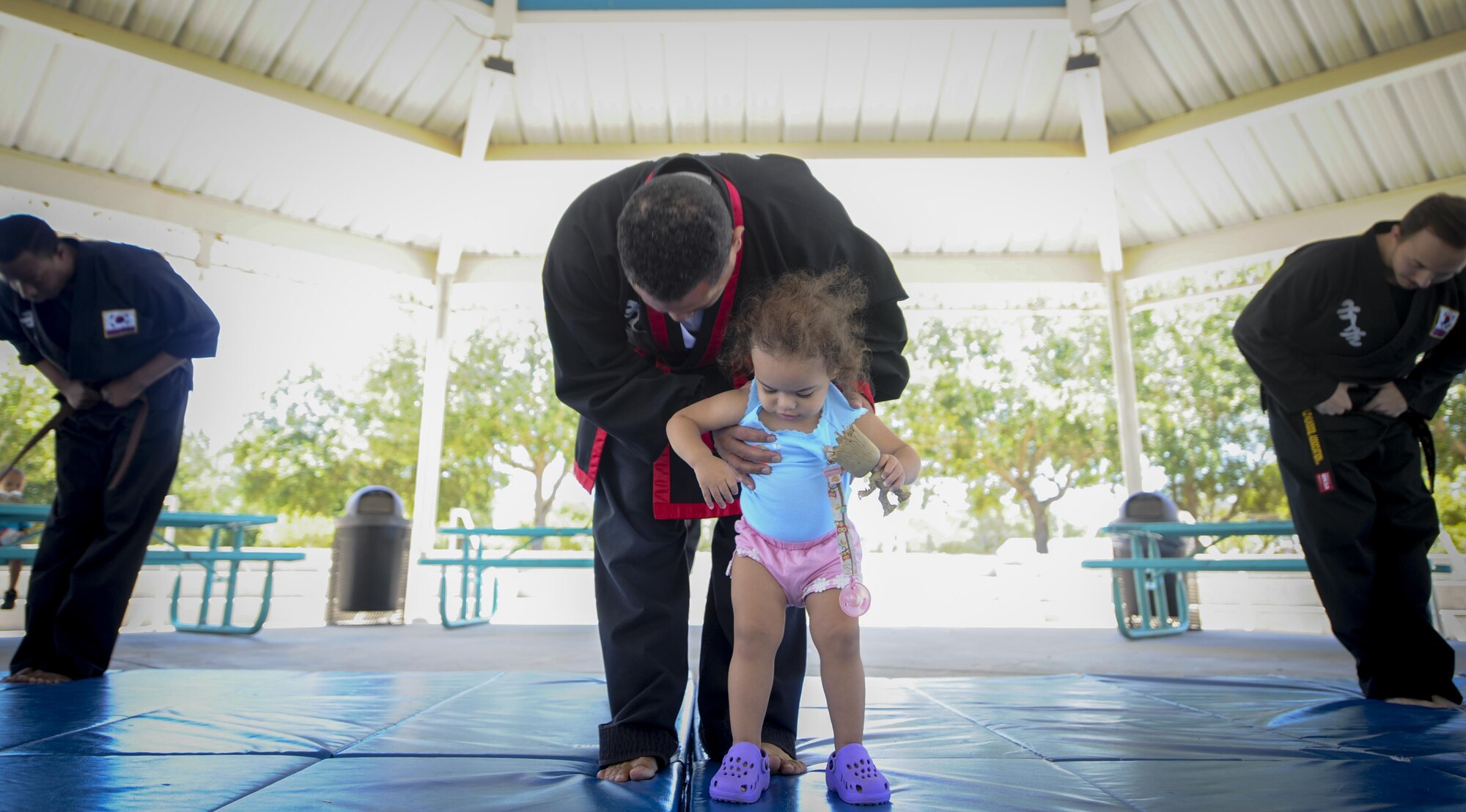Amado Garcia, a Kuk Sool Won instructor, bows with his daughter after completing a demonstration at the Asian American and Pacific Islander Cultural Day event at Hurlburt Field, Fla., May 25, 2017. Kuk Sool Won is a martial art system that was founded in 1961. The event included the demonstration, free food and a hula demonstration. (U.S. Air Force photo by Airman 1st Class Dennis Spain )