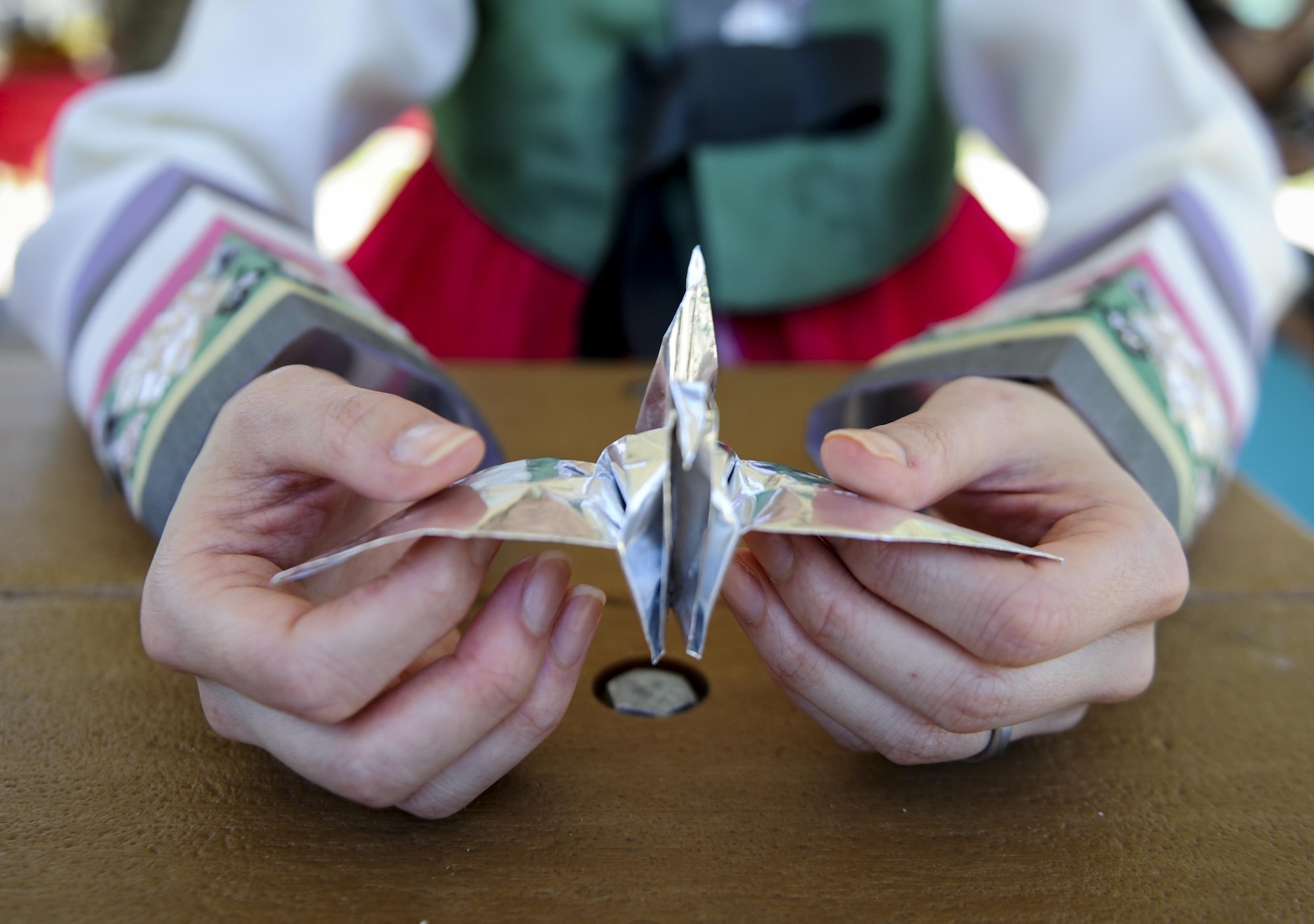 First Lt. Uiri Han, an executive officer with Headquarters Air Force Special Operations Command, folds a crane out of origami papers during the Asian American and Pacific Islander Cultural Day event at Hurlburt Field, Fla., May 25, 2017. Origami is a traditional form of entertainment which dates of origin remain unknown. The Asian American and Pacific Islander Cultural Day event included the demonstration, free food and a hula demonstration. (U.S. Air Force photo by Airman 1st Class Dennis Spain)