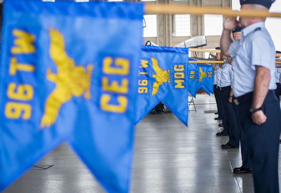 The 96th Test Wing’s guidons are held at present arms during the wing’s change of command ceremony at Eglin Air Force Base, Fla., May 31.  Brig. Gen. Christopher Azzano relinquished command to Brig. Gen. Evan Dertien.  The command position is Dertien’s third assignment to Team Eglin.  (U.S. Air Force photo/Samuel King Jr.)