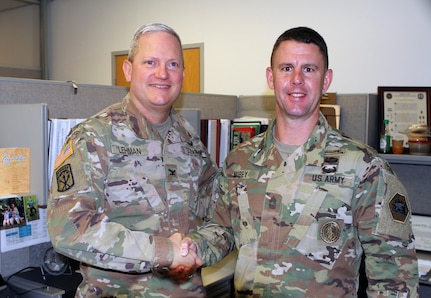 Master Sgt. Brandon S. Morey, right, assistant inspector general at the California National Guard’s Inspector General’s Office, is congratulated by Col. Robert J. Lehman, State Inspector General, May 12, 2017, after earning runner-up in the prestigious Dept. of the Army Inspector General Noncommissioned Officer of the Year competition recently. 