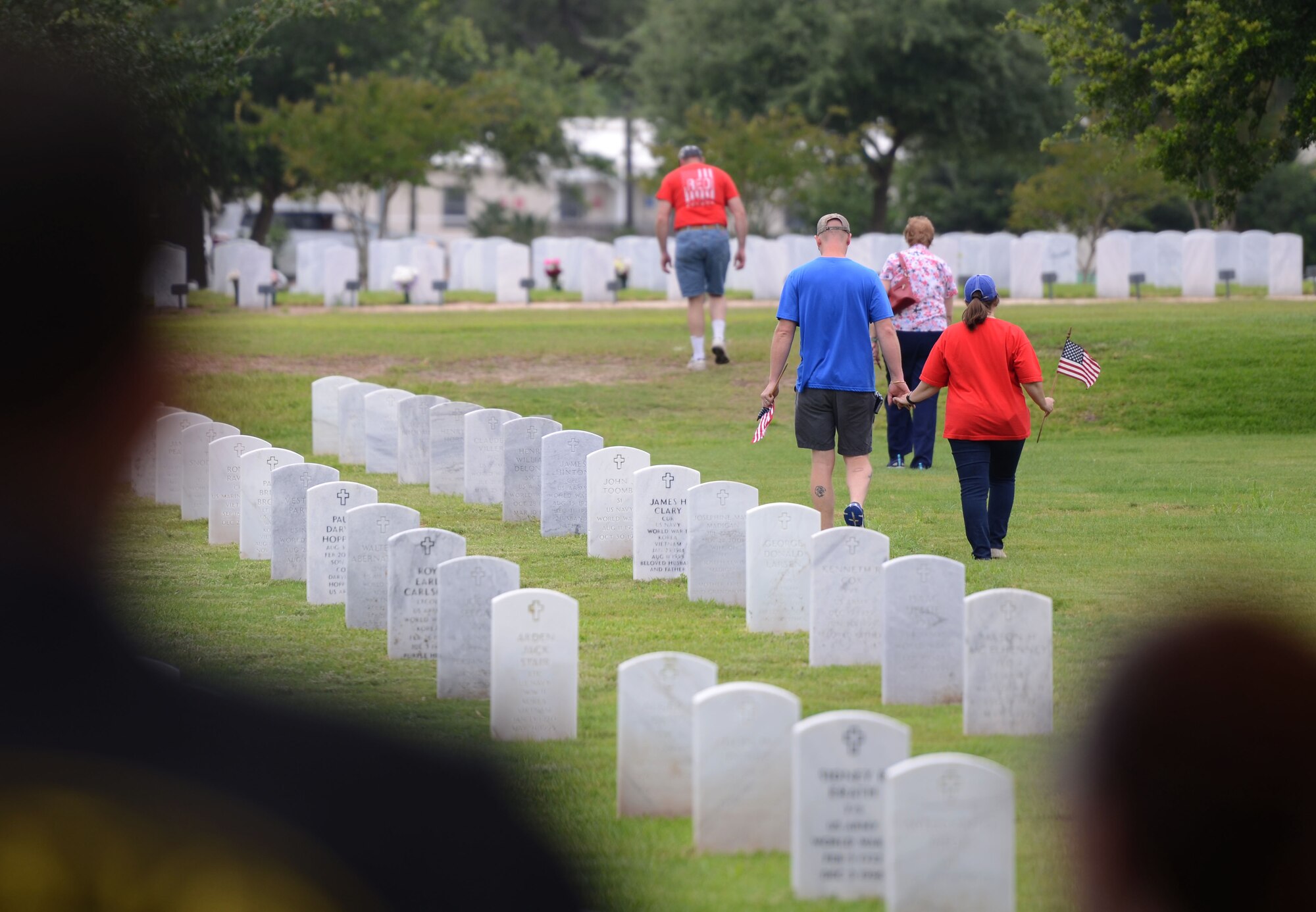 Local veterans, family members and Keesler Air Force Base personnel place U.S. flags on grave sites at Biloxi National Cemetery in recognition of Memorial Day, May 27, 2017, in Biloxi, Miss. The flags were posted to honor and remember the lives of fallen heroes of the U.S. military. (U.S. Air Force photo by Andrew Whitman)