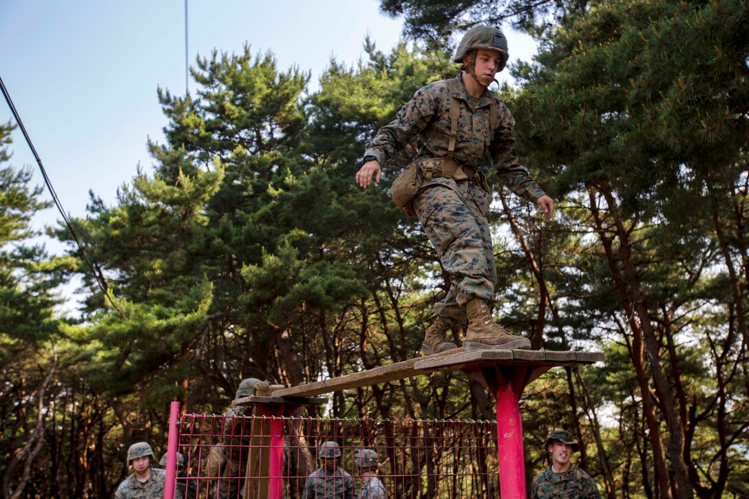 Marines and sailors negotiate a balance beam as part of the Leadership Reaction Course at Camp Mujuk, South Korea, May 29, 2017. Marine Corps photo by Cpl. David A. Diggs