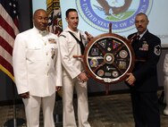 FORT EUSTIS, Va. - Chief Yeoman Owen Watson, flag writer, Joint Task Force Civil Support is presented his shadowbox during his retirement ceremony May 18, 2017. Watson served 29 honorable years in the United States Navy. (Official DOD photo by MC2 Benjamin Liston)