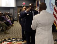 FORT EUSTIS, Va. - Chief Yeoman Owen Watson, flag writer, Joint Task Force Civil Support receives the national ensign during his retirement ceremony May 18, 2017. Watson served 29 honorable years in the United States Navy. (Official DOD photo by MC2 Benjamin Liston)