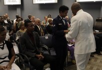FORT EUSTIS, Va. - Chief Yeoman Owen Watson, flag writer, Joint Task Force Civil Support hands flowers to his daughter during his retirement ceremony May 18, 2017. Watson served 29 honorable years in the United States Navy. (Official DOD photo by MC2 Benjamin Liston)