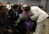 FORT EUSTIS, Va. - Chief Yeoman Owen Watson, flag writer, Joint Task Force Civil Support presents flowers to his mother during his retirement ceremony May 18, 2017. Watson served 29 honorable years in the United States Navy. (Official DOD photo by MC2 Benjamin Liston)