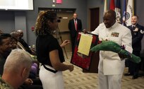 FORT EUSTIS, Va. - Chief Yeoman Owen Watson, flag writer, Joint Task Force Civil Support presents flowers to his wife during his retirement ceremony May 18, 2017. Watson served 29 honorable years in the United States Navy. (Official DOD photo by MC2 Benjamin Liston)