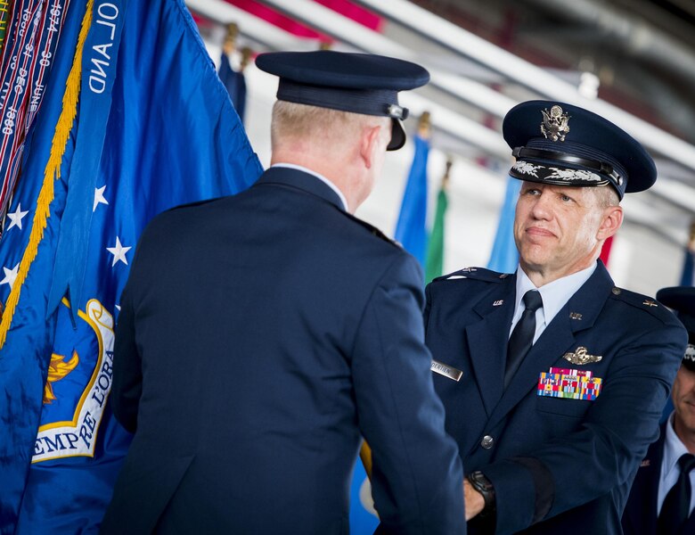 Brig. Gen. Evan Dertien accepts the 96th Test Wing guidon from Maj. Gen. David Harris, Air Force Test Center commander, during the wing's change of command ceremony at Eglin Air Force Base, Fla., May 31. Brig. Gen. Christopher Azzano relinquished command to Dertien.  The command position is Dertien’s third assignment to Team Eglin. (U.S. Air Force photo/Samuel King Jr.)