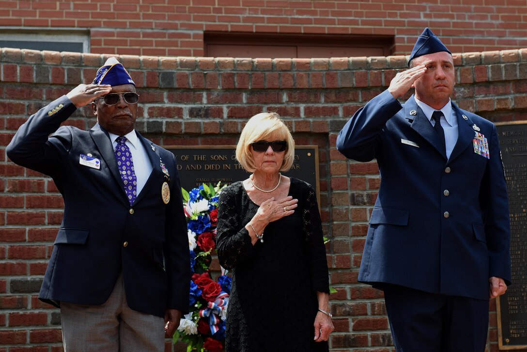 Sylvania Wilkerson (left), the Military Order of the Purple Heart commander, Brenda Albritton (center), U.S. Air Force Gold Star wife, and Chief Master Sgt. Eugene Elking, acting 4th Fighter Wing command chief, present arms during the playing of taps, May 29, 2017, at the Wayne County Veterans Memorial in Goldsboro, North Carolina. The Wayne County Veterans & Patriots Coalition hosted a moment of silence in recognition of Memorial Day. (U.S. Air Force photo by Senior Airman Ashley Maldonado-Suarez)
