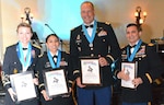 The Knowlton Award is awarded to select individuals who have demonstrated the high standards of integrity, moral character, professional competency and selflessness, and who have contributed significantly to the promotion of the Military Intelligence Corps. From left are award recipients Maj. Heather Richards, Maj. Melissa Tovar, Maj. Theodore Severn and Chief Warrant Officer 3 Frank Kuylen.


